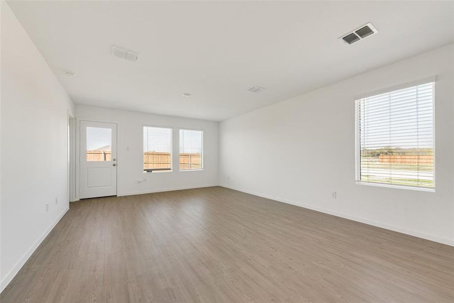 Empty room with hardwood / wood-style floors