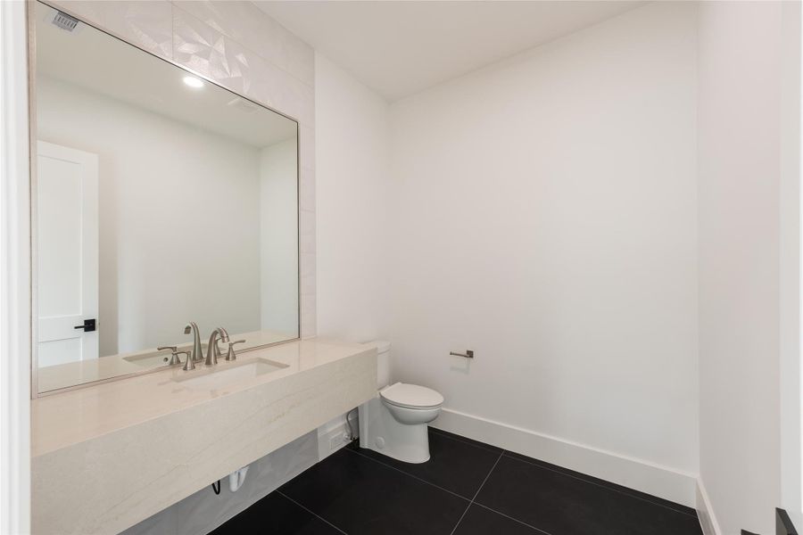 A convenient upstairs half bath with a clean design