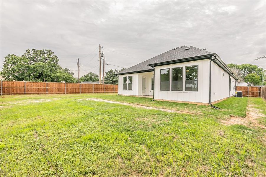 Rear view of property featuring central AC unit, a shingled roof, and board and batten siding Rear view of property featuring central AC unit, a shingled roof, and board and batten siding