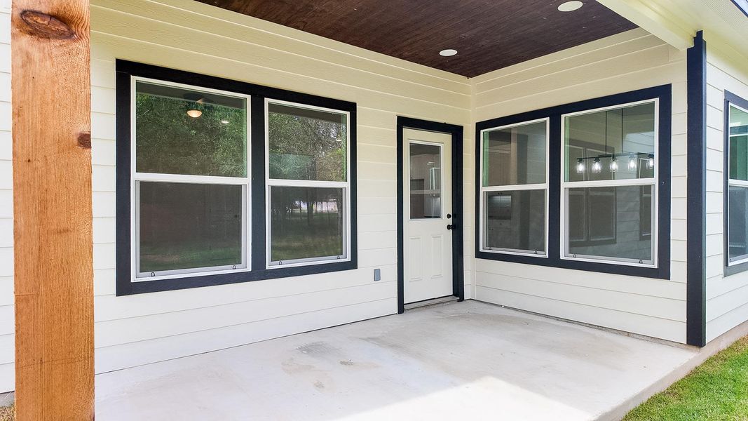 A sheltered concrete patio offers an ideal space for outdoor relaxation and entertaining.