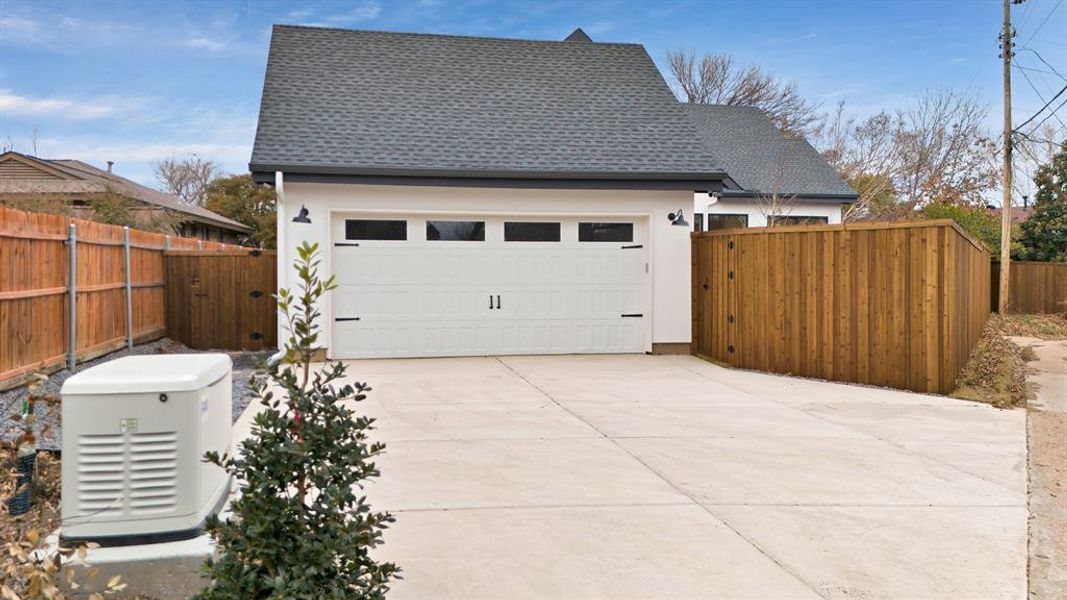 Driveway with rear facing garage with Generac Generator