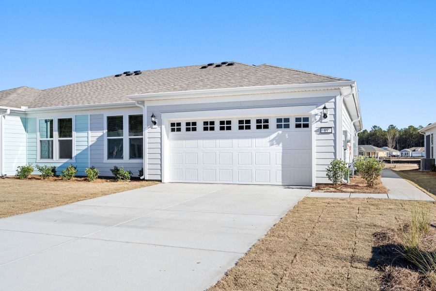 Front exterior of a new home in Sun City Hilton Head, Bluffton, SC, highlighting curb appeal (Image 2). Front exterior of a new home in Sun City Hilton Head, Bluffton, SC, highlighting curb appeal (Image 2).