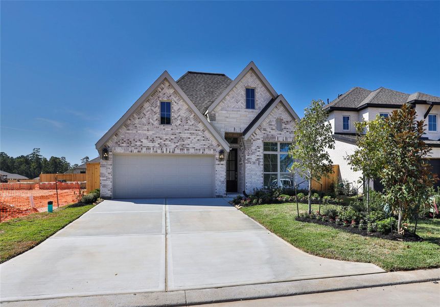 Front exterior of a new home in Grand Central Park 45', Conroe, TX, highlighting curb appeal (Image 1). Front exterior of a new home in Grand Central Park 45', Conroe, TX, highlighting curb appeal (Image 1).