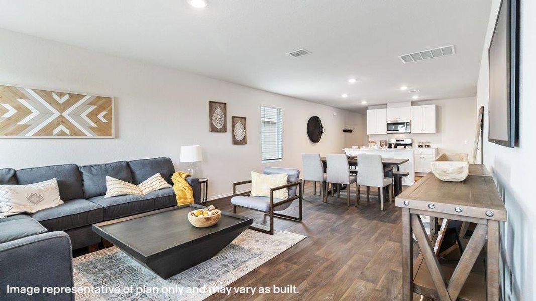 An open floorplan seamlessly connects a comfortable living area with a bright, functional kitchen. An open floorplan seamlessly connects a comfortable living area with a bright, functional kitchen.