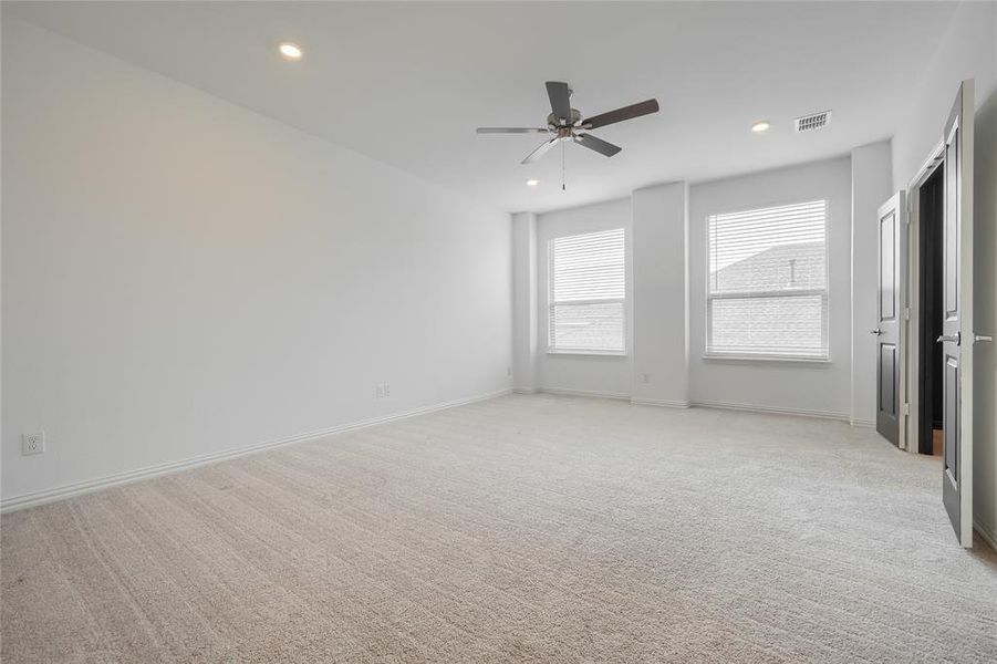 Unfurnished bedroom featuring light carpet, recessed lighting, and a ceiling fan Unfurnished bedroom featuring light carpet, recessed lighting, and a ceiling fan