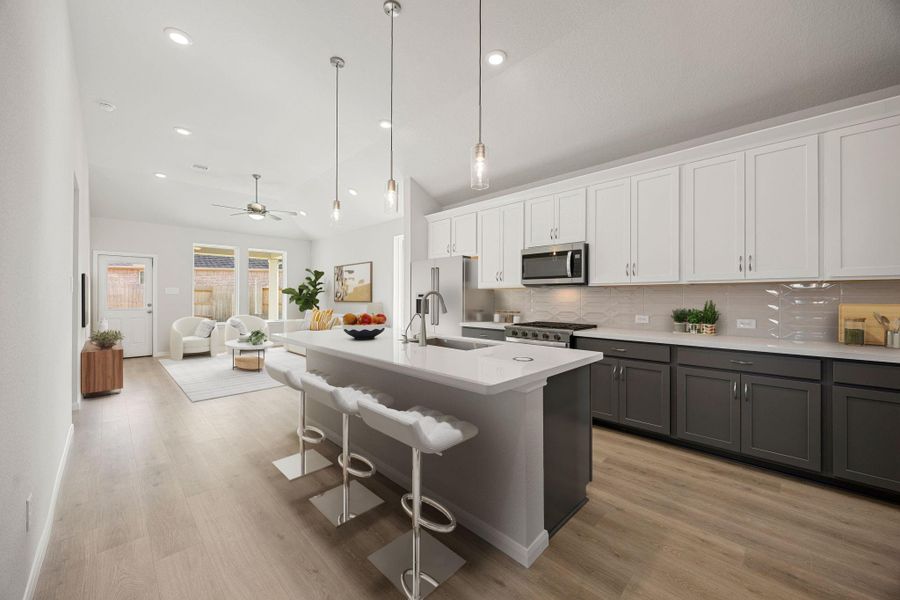 An immaculate, modern chef's kitchen featuring stylish two-toned cabinetry with crisp white upper cabinets and a sleek gray base, complemented by pristine white quartz countertops and a subtle subway tile backsplash. The space is fully equipped with stainless steel appliances, including a gas range and built-in microwave. Durable, light wood-look flooring and ample recessed lighting complete the look, which is both bright and functional. An immaculate, modern chef's kitchen featuring stylish two-toned cabinetry with crisp white upper cabinets and a sleek gray base, complemented by pristine white quartz countertops and a subtle subway tile backsplash. The space is fully equipped with stainless steel appliances, including a gas range and built-in microwave. Durable, light wood-look flooring and ample recessed lighting complete the look, which is both bright and functional.