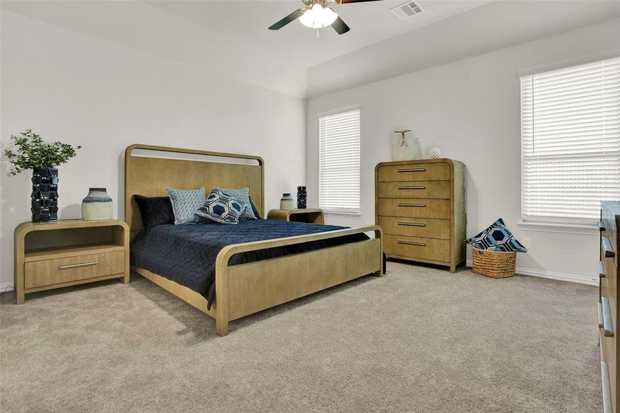 Carpeted bedroom with ceiling fan