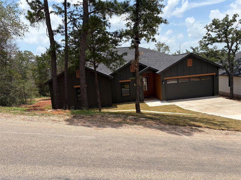 A modern facade with a dark exterior and integrated garage creates a striking presence. A modern facade with a dark exterior and integrated garage creates a striking presence.