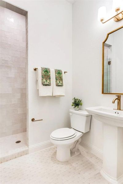 Bathroom featuring a shower stall and tile patterned floors