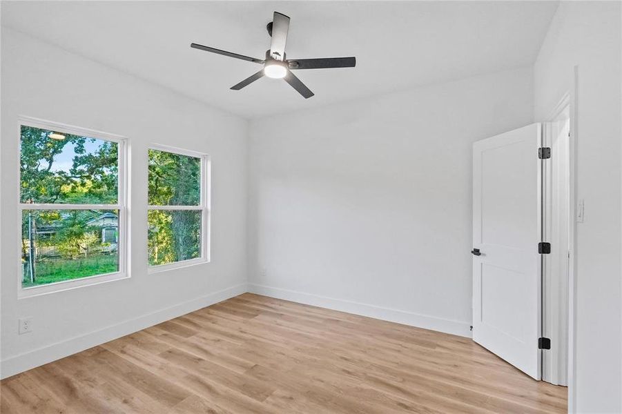 Unfurnished room featuring light hardwood / wood-style flooring and ceiling fan