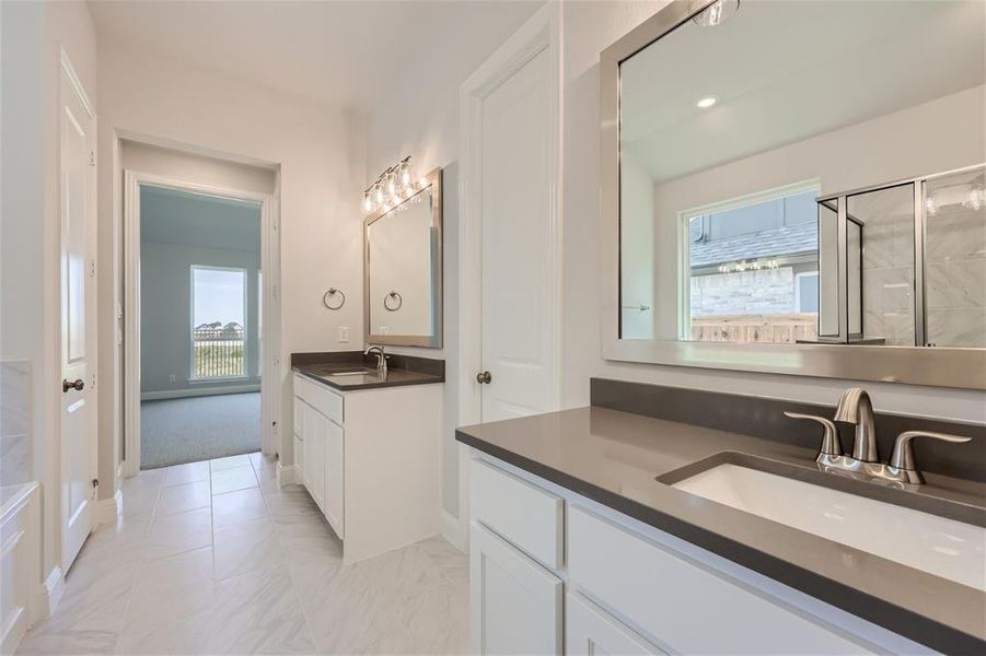 Bathroom featuring dual vanity and tile floors