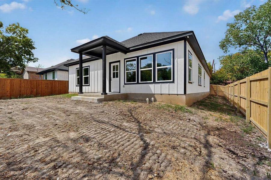 Back of house featuring a fenced backyard, board and batten siding, and roof with shingles Back of house featuring a fenced backyard, board and batten siding, and roof with shingles