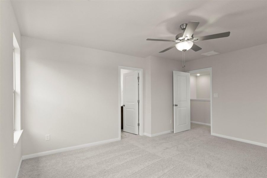 Unfurnished bedroom with light carpet and ceiling fan