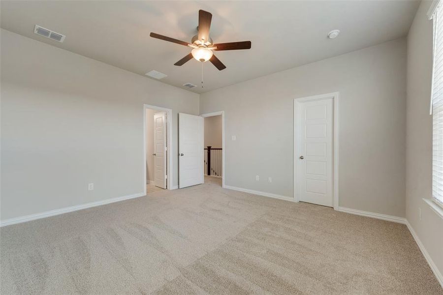 Unfurnished room featuring light carpet