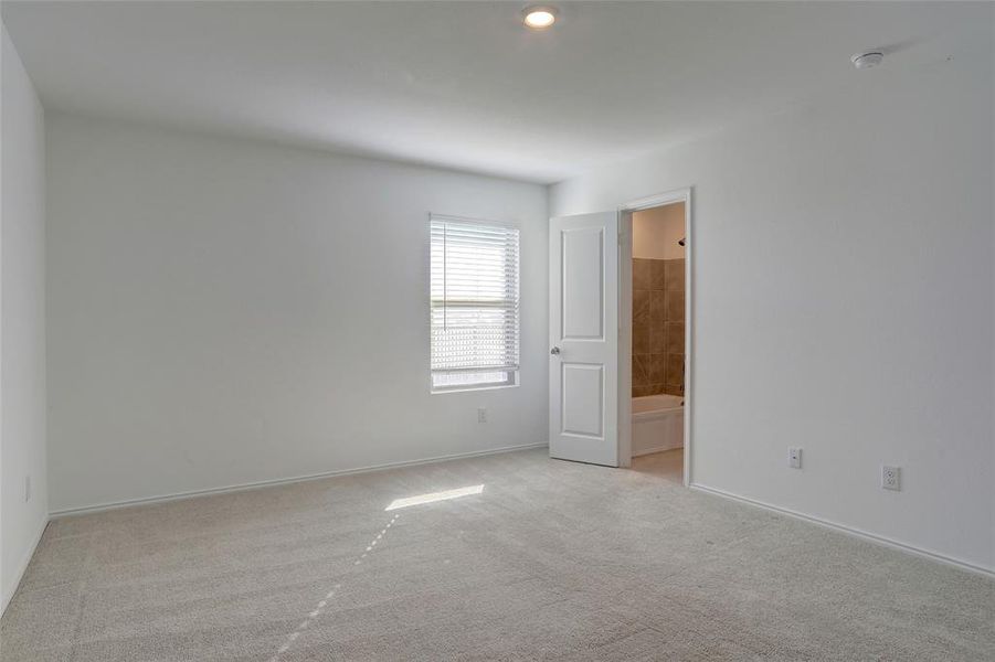 Unfurnished room with light colored carpet and recessed lighting