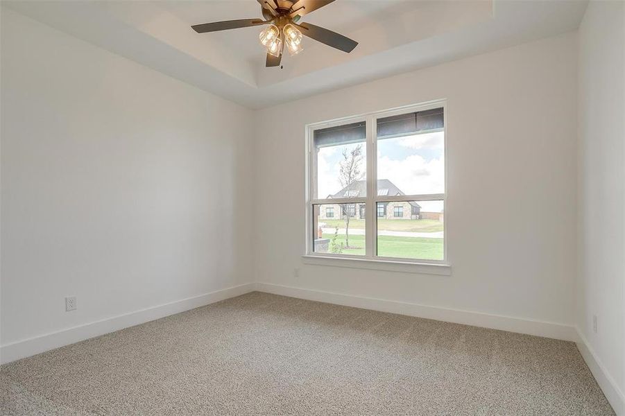 Spare room featuring ceiling fan and carpet floors