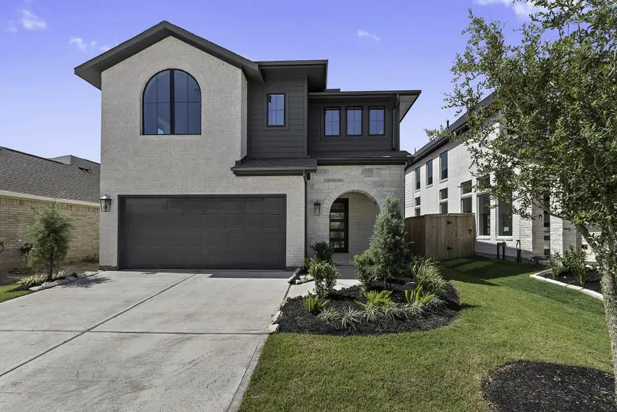 Front exterior of a new home in Candela, Richmond, TX, highlighting curb appeal (Image 2). Front exterior of a new home in Candela, Richmond, TX, highlighting curb appeal (Image 2).