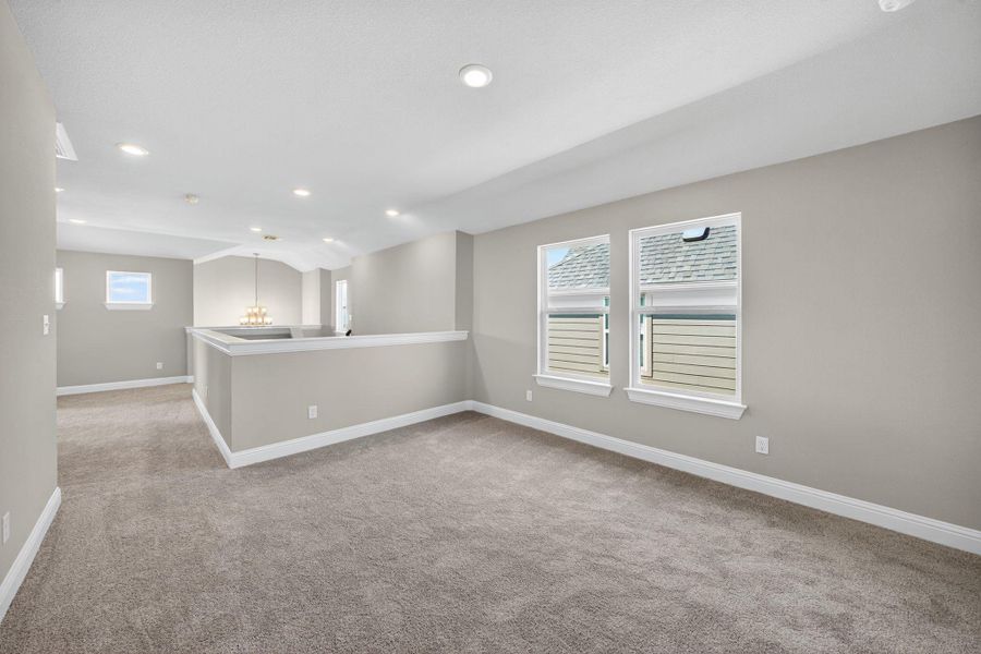 Unfurnished room featuring light carpet, recessed lighting, and a chandelier Unfurnished room featuring light carpet, recessed lighting, and a chandelier