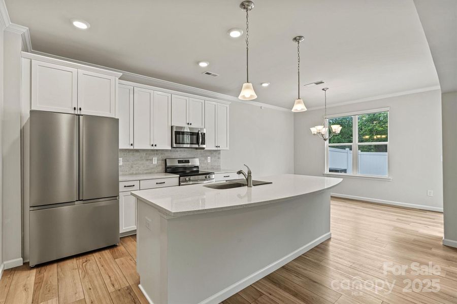 Flooded with natural light, this kitchen shines with sleek stainless steel appliances—including a refrigerator with built-in water dispenser, all ready for move-in convenience. Flooded with natural light, this kitchen shines with sleek stainless steel appliances—including a refrigerator with built-in water dispenser, all ready for move-in convenience.