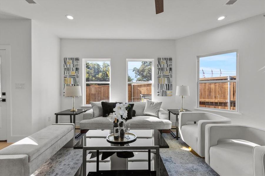 Living room with recessed lighting, light wood finished floors, and ceiling fan Living room with recessed lighting, light wood finished floors, and ceiling fan