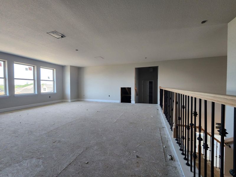 Spare room with a textured ceiling and baseboards