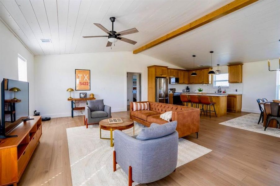 Open concept living space featuring a living room, dining area, and kitchen