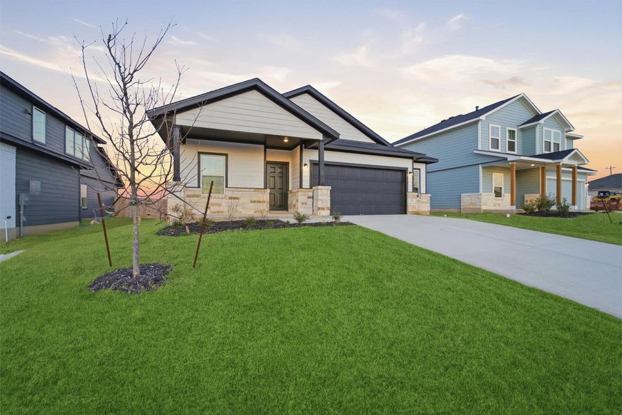 Front exterior of a new home in Hunters Glen, Jarrell, TX, highlighting curb appeal (Image 2).