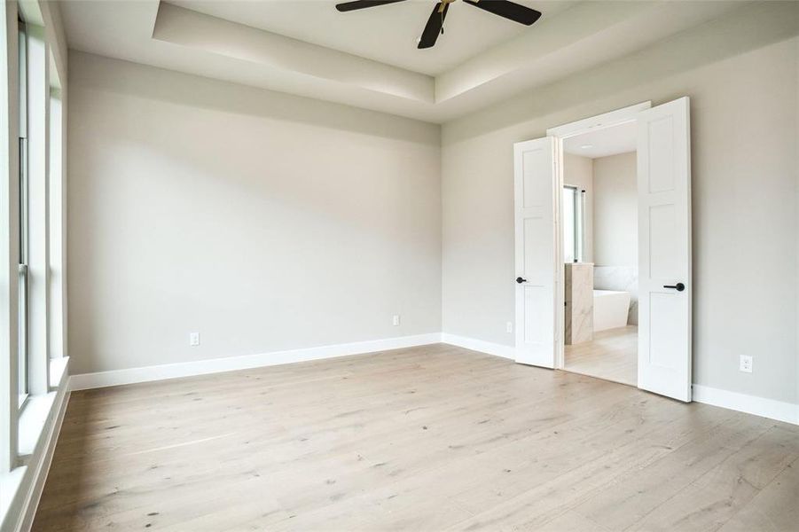 Double doors lead to primary master bath Double doors lead to primary master bath