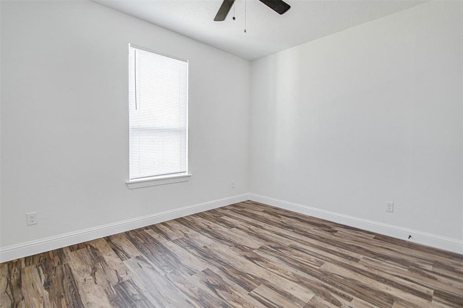 Spare room with ceiling fan and wood-type flooring