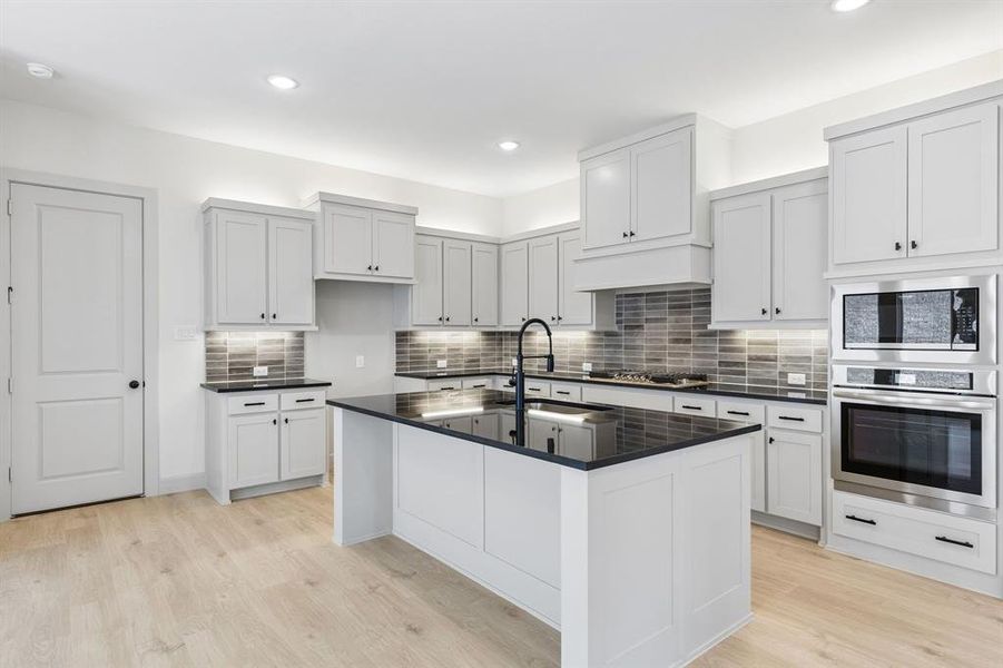 The spacious kitchen island creates the perfect place for friends and family to gather round. The spacious kitchen island creates the perfect place for friends and family to gather round.