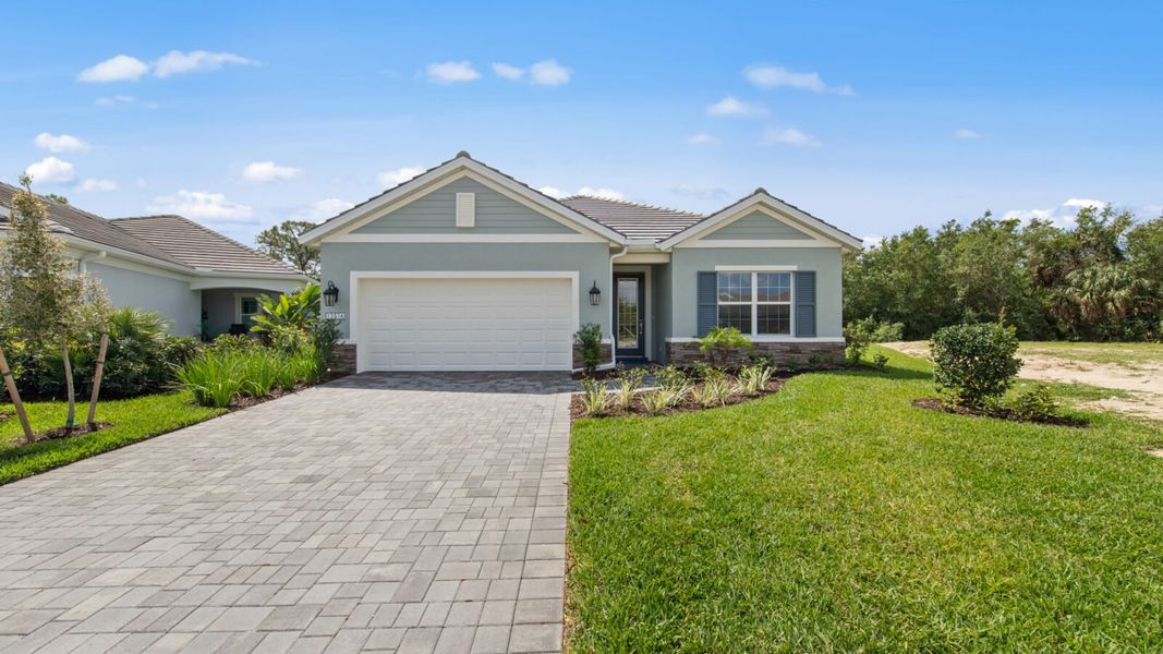Front exterior of a new home in Verandah, Fort Myers, FL, highlighting curb appeal (Image 18).