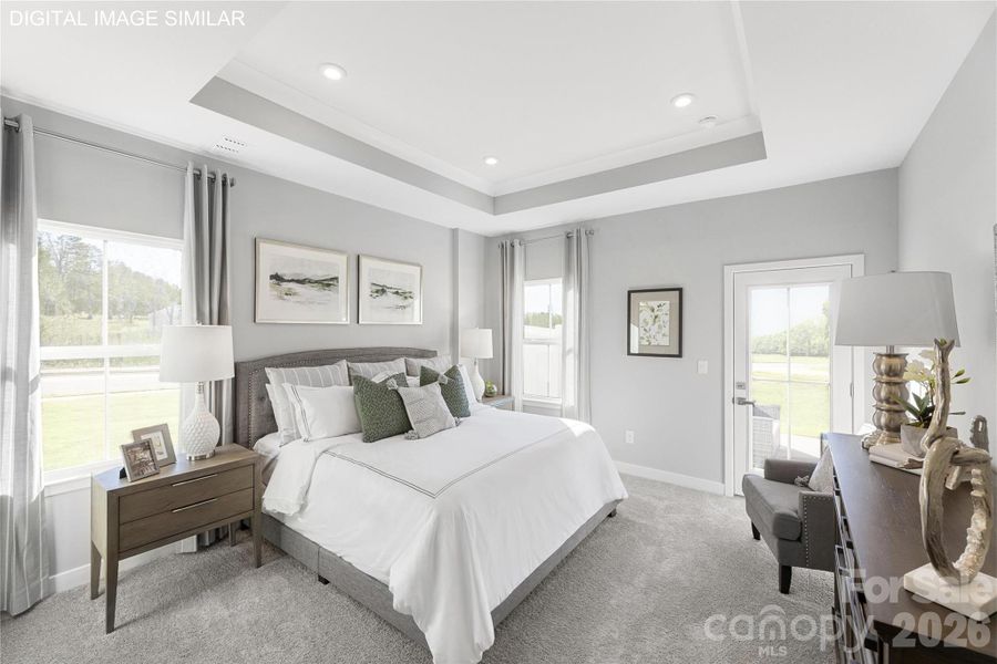 Spacious first-floor primary suite with tray ceiling and abundant natural light—your own private retreat. Spacious first-floor primary suite with tray ceiling and abundant natural light—your own private retreat.