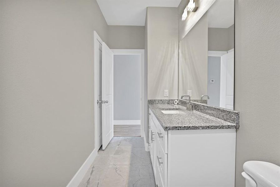 Bathroom featuring vanity and toilet