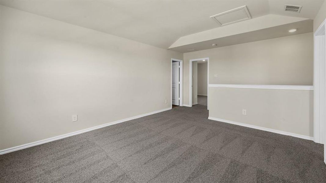Spacious room featuring gray carpet, light neutral wall paint, and white trim