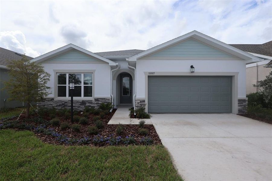 Front exterior of a new home in The Peninsula at Rhodine Lake, Riverview, FL, highlighting curb appeal (Image 1). Front exterior of a new home in The Peninsula at Rhodine Lake, Riverview, FL, highlighting curb appeal (Image 1).