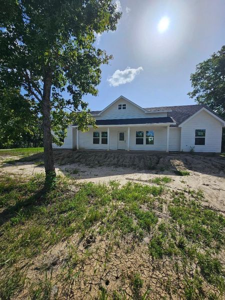 Front exterior of a new home in , Dayton, TX, highlighting curb appeal (Image 1).