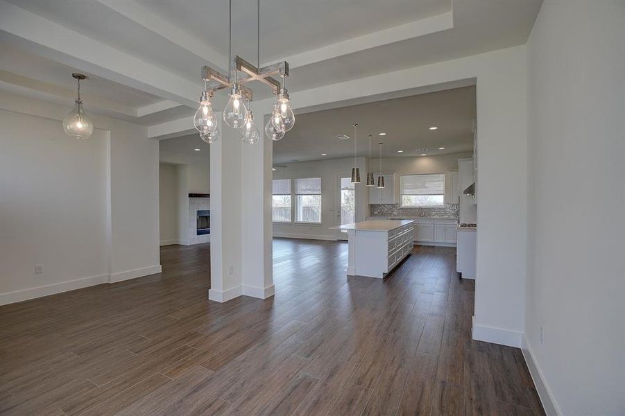 Kitchen/family room, with fireplace. Recessed can lighting, ceiling fan, and wood look ceramic tile floors.