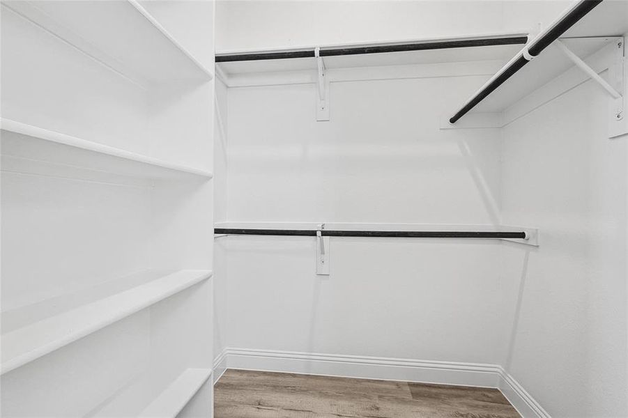 Spacious closet featuring light wood-type flooring