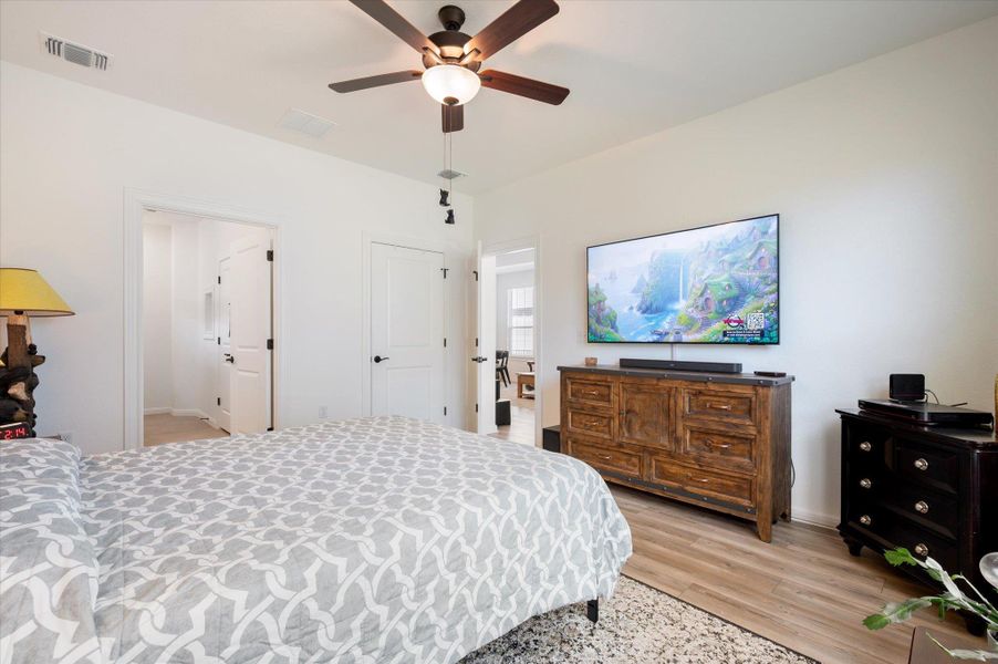 Primary Bedroom with light wood-style floors and ceiling fan Primary Bedroom with light wood-style floors and ceiling fan