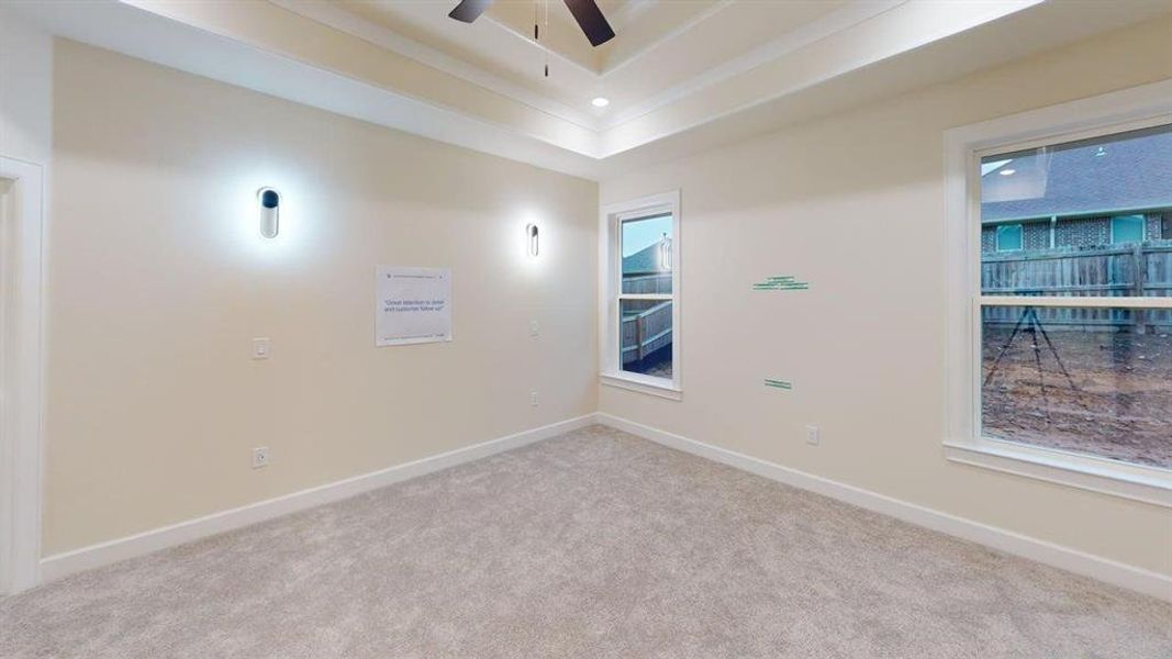Spare room with carpet floors, a ceiling fan, a tray ceiling, and recessed lighting