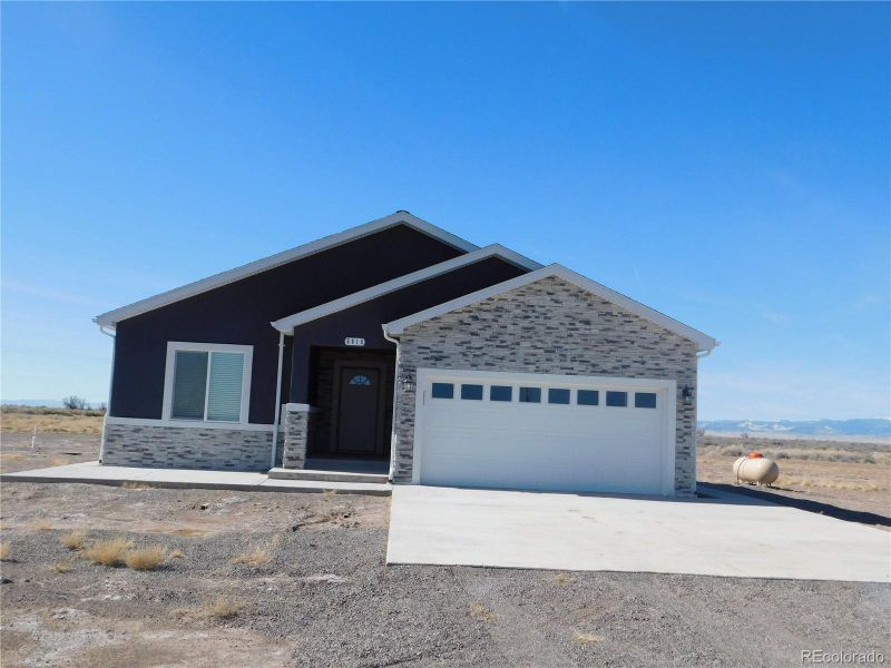 Front exterior of a new home in , Alamosa, CO, highlighting curb appeal (Image 1).
