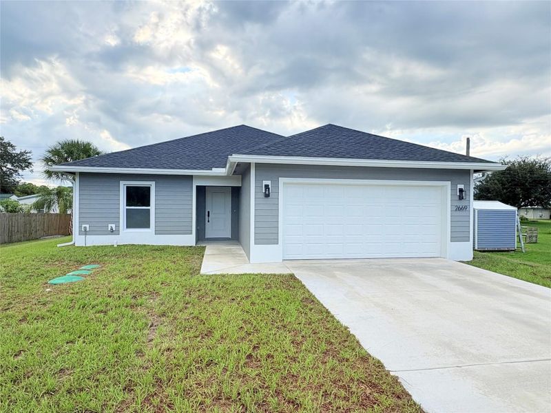Front exterior of a new home in , Okeechobee, FL, highlighting curb appeal (Image 19).
