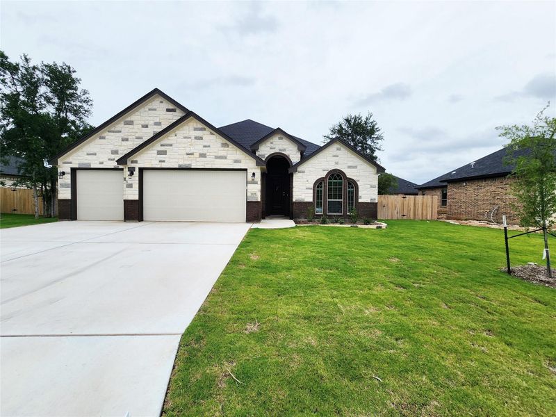 A well-maintained lawn welcomes you to this residence, showcasing a clean driveway and attached garage. A well-maintained lawn welcomes you to this residence, showcasing a clean driveway and attached garage.