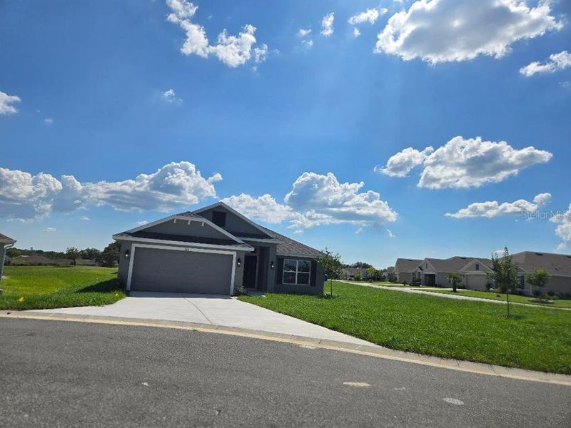 Front exterior of a new home in Twisted Oaks, Beverly Hills, FL, highlighting curb appeal (Image 19).