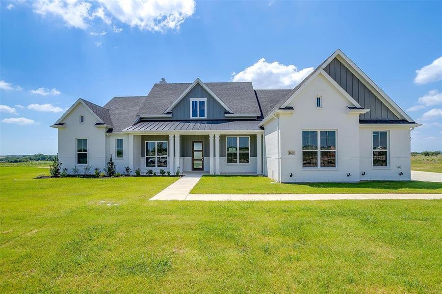 Modern inspired farmhouse featuring a front yard