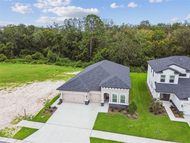 Front exterior of a new home in Hidden Ridge, New Port Richey, FL, highlighting curb appeal (Image 29).