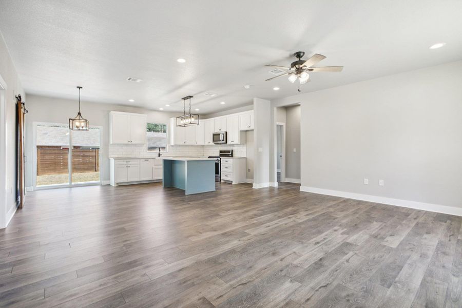 Unfurnished living room with recessed lighting, light wood-style floors, and a ceiling fan