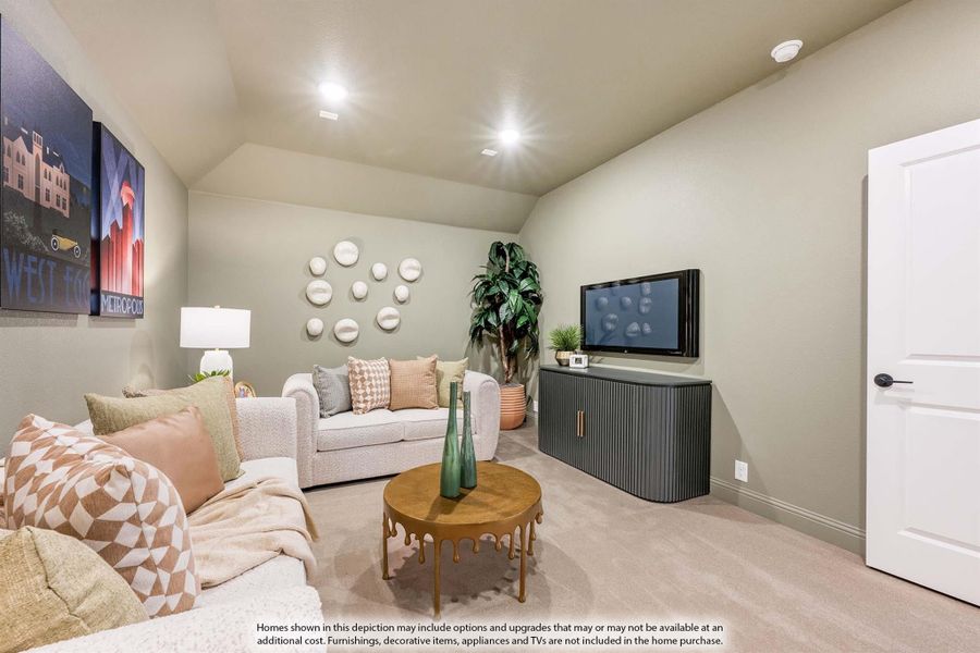 Bonus room with vaulted ceiling, carpet flooring, two sofas, and a media console with wall-mounted TV