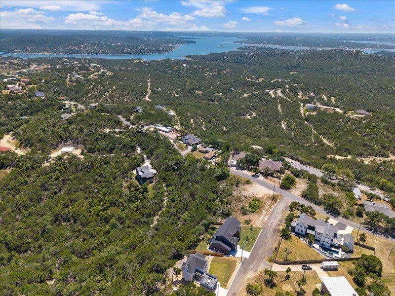 Aerial view of property's location with a nearby body of water and nearby suburban area