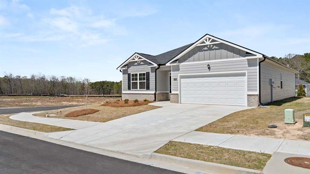 Front exterior of a new home in Champion's Run, Lithonia, GA, highlighting curb appeal (Image 1).